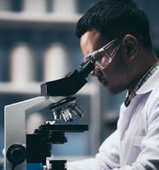 Scientist looking through a microscope