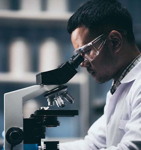 Man looking into a microscope